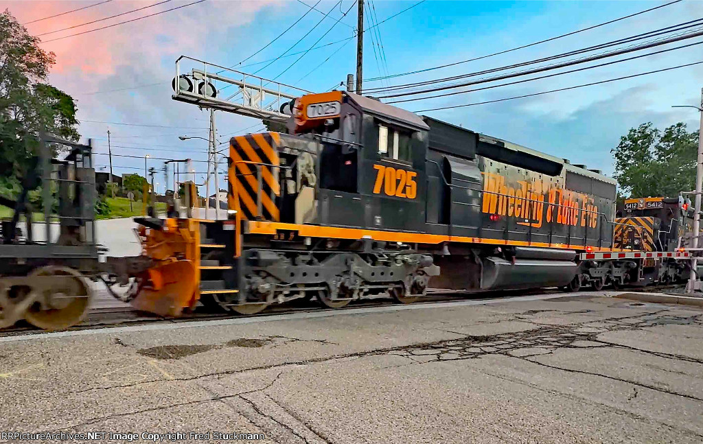 WE 7025 helps pull 120 cars west.